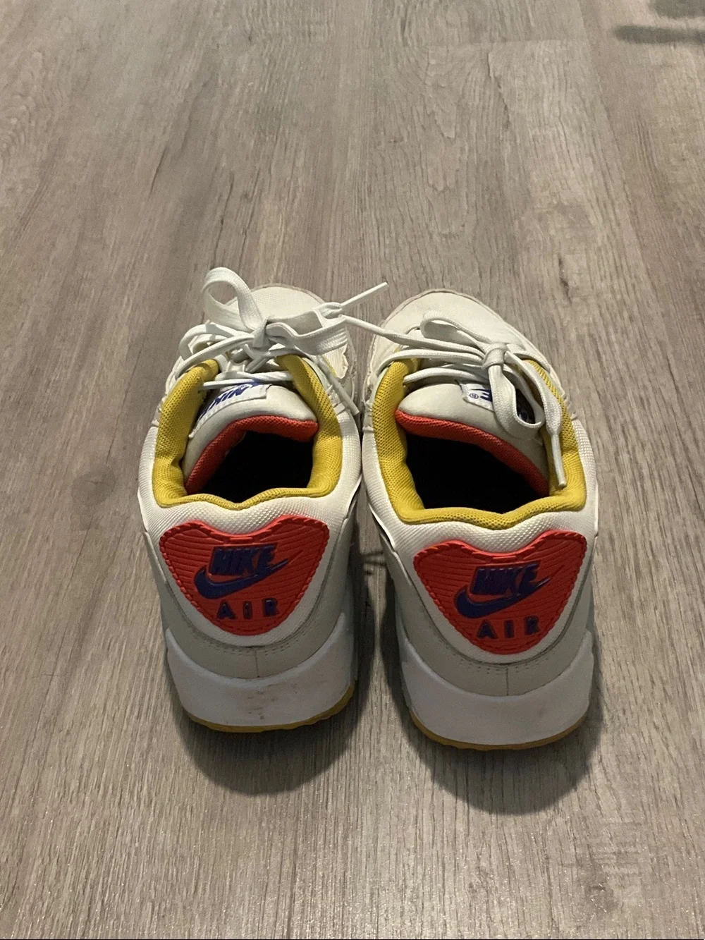 Nike White Sneakers with Blue, Yellow and Red Accents
